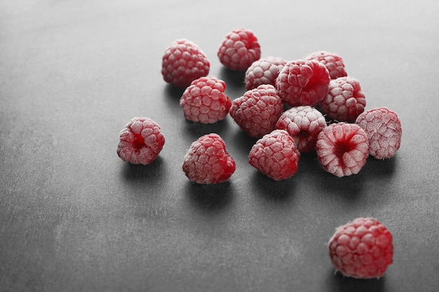 Fresh raspberry in sugar powder on table