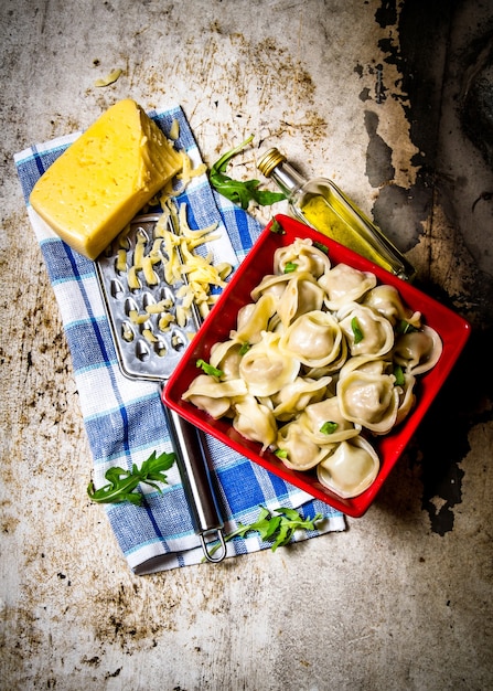 Fresh ravioli stuffed with cheese on the fabric.