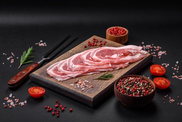 Fresh raw bacon sliced with spices and herbs