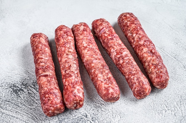 Fresh raw beef meat kebabs sausages.