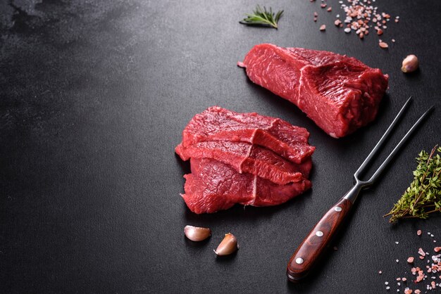 Fresh raw beef meat to make delicious juicy steak with spices and herbs. Preparation for grilled meat