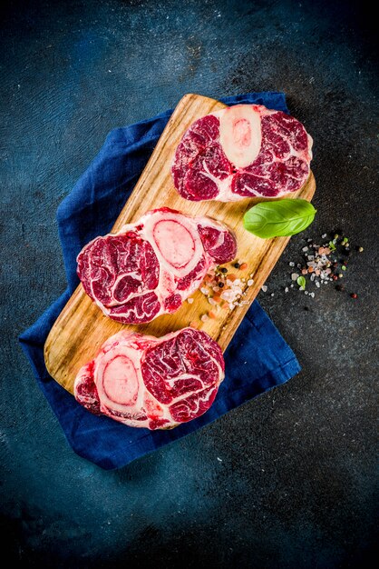 Fresh raw beef meat with spices for cooking, top view copy space