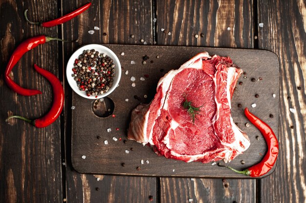 fresh raw beef steak on wood cutting board
