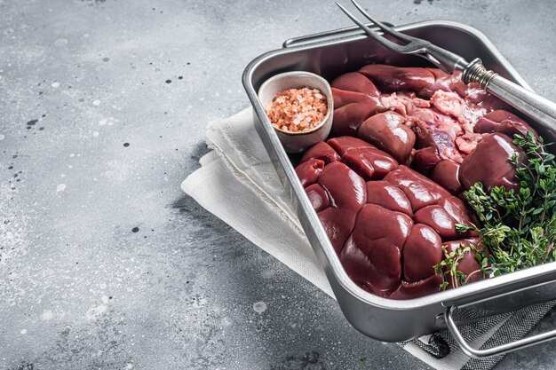 Fresh Raw Beef veal kidney in kitchen tray Gray background Top view Copy space
