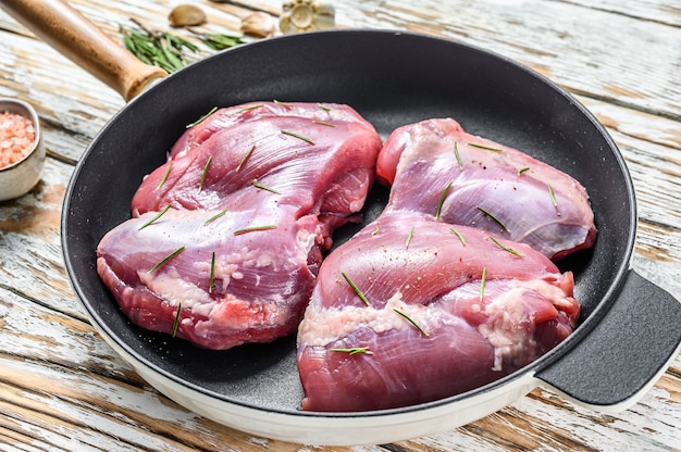 Fresh raw boneless Turkey thigh fillet in a pan ready to cook