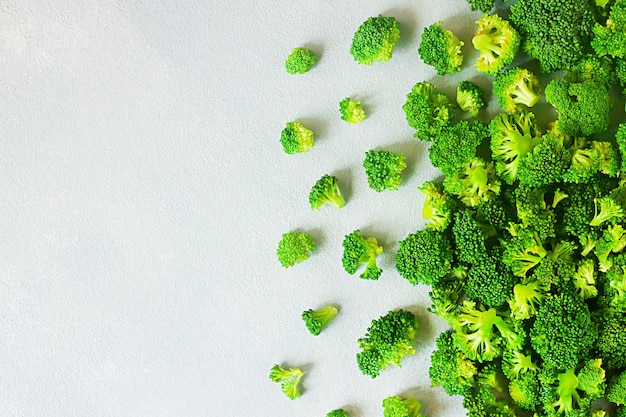 Fresh raw broccoli with copy space on grey