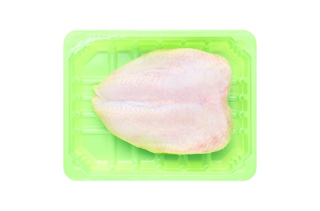 Photo fresh raw chicken breast on a green plastic