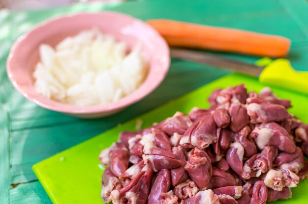 Fresh raw chicken hearts cut for preparation