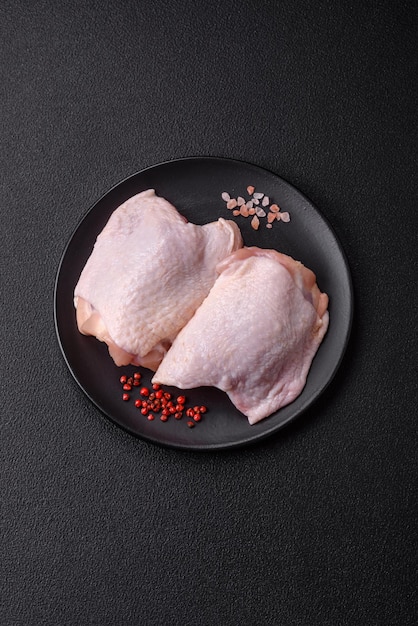 Fresh raw chicken thighs with salt and spices