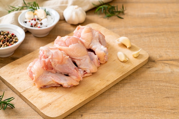 fresh raw chicken wings (drumette or drumstick) on wooden board