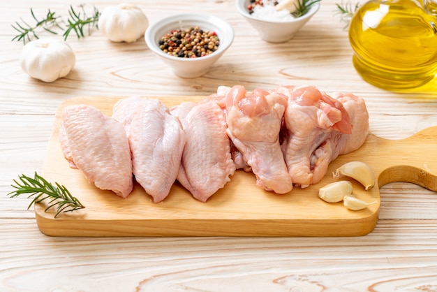 fresh raw chicken wings on wooden board