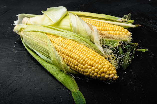 Fresh raw corns set, on black background