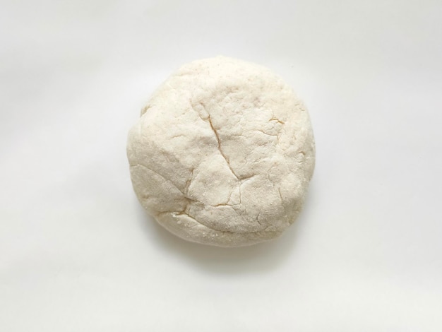 Fresh raw dough on white background top view