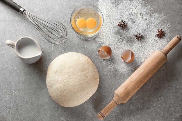 Fresh raw dough with ingredients on table