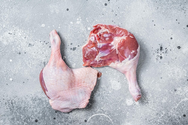 Fresh raw duck legs on a kitchen table Gray background Top view