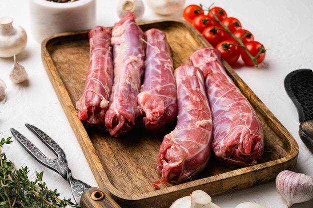 Fresh raw duck neck without skin set, on white stone table background