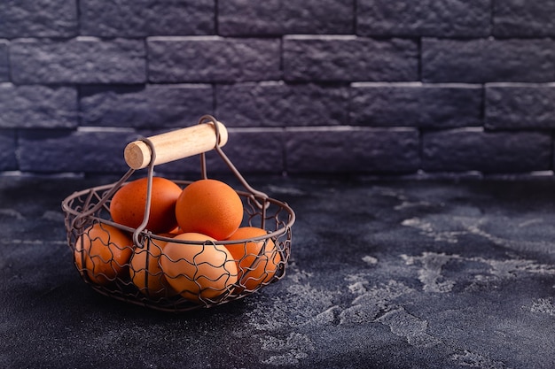 Fresh raw eggs in a metal basket