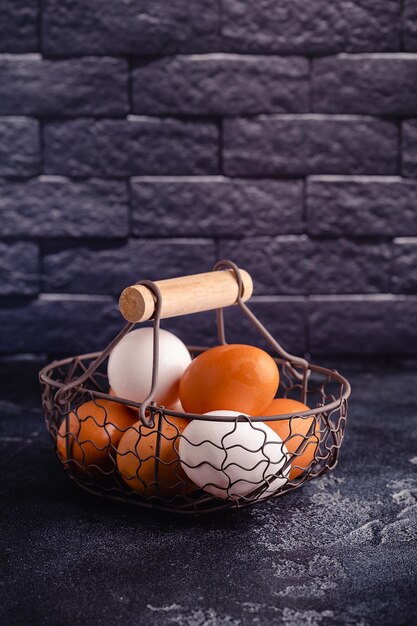 Fresh raw eggs in a metal basket