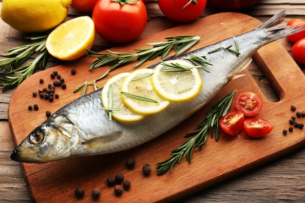 Fresh raw fish and food ingredients on table