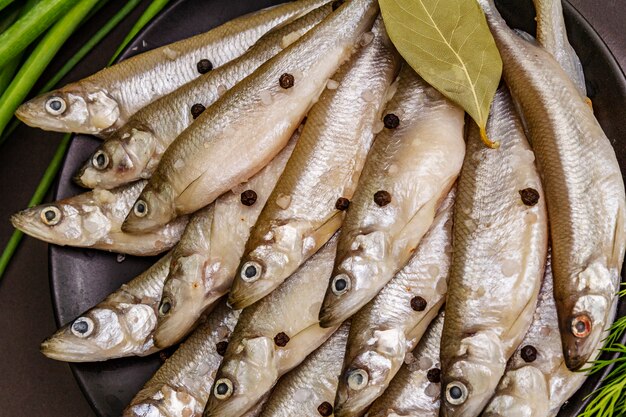 Fresh raw fish smelt or sardines ready for cooking