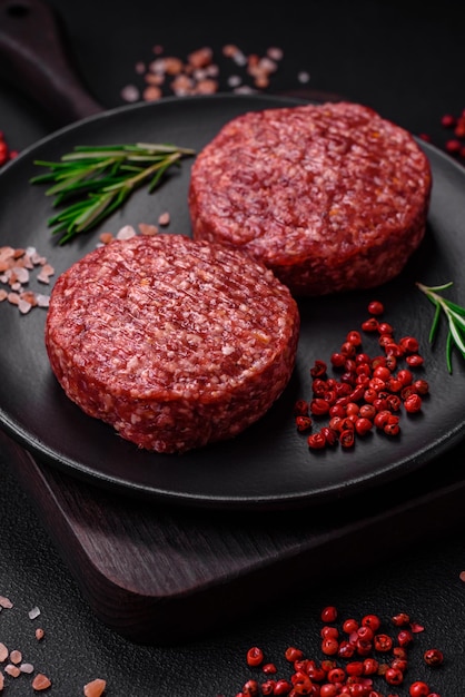 Fresh raw ground beef burger patty with salt and spices