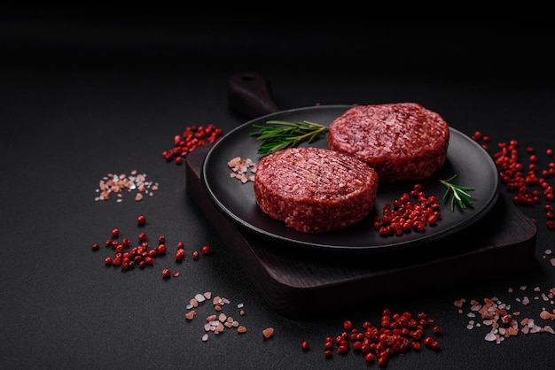 Fresh raw ground beef burger patty with salt and spices