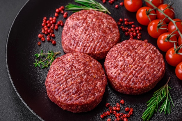 Fresh raw ground beef burger patty with salt and spices