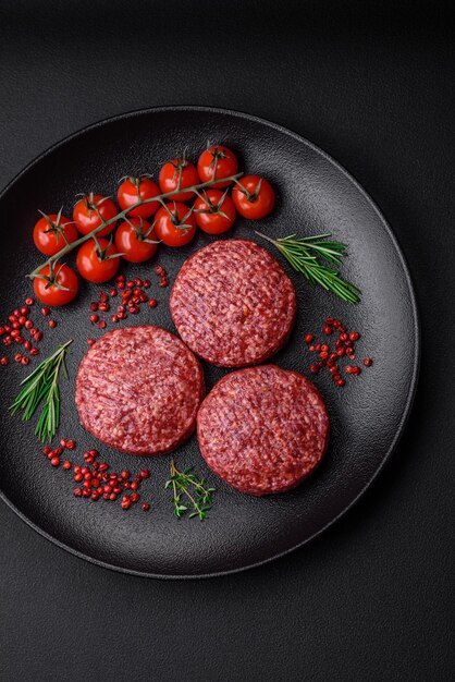 Fresh raw ground beef burger patty with salt and spices