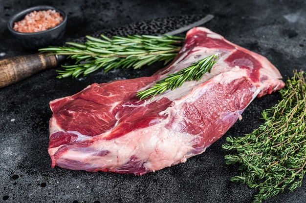 Fresh Raw lamb or goat shoulder meat with butcher knife