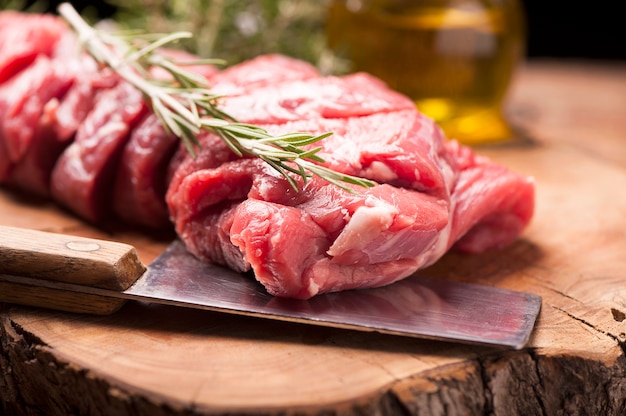 Fresh raw meat on old wooden table