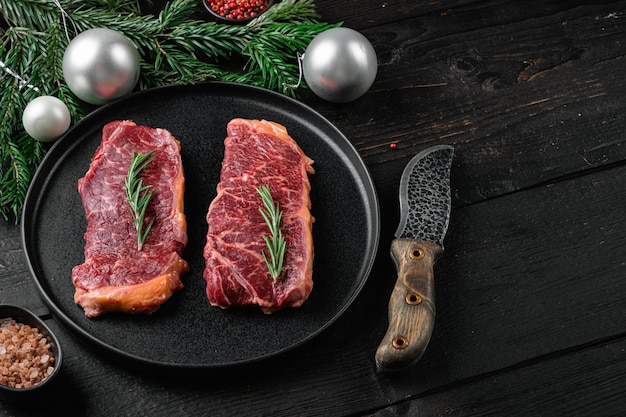 Fresh raw meat steak set, on black wooden table background, with copy space for text