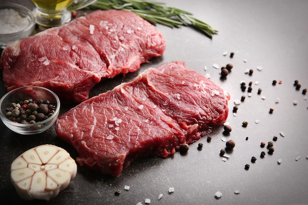 Fresh raw meat with spices on table