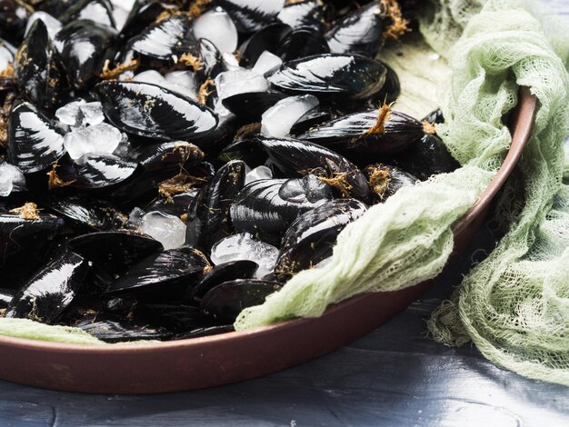 Fresh raw mussels on rusty tray