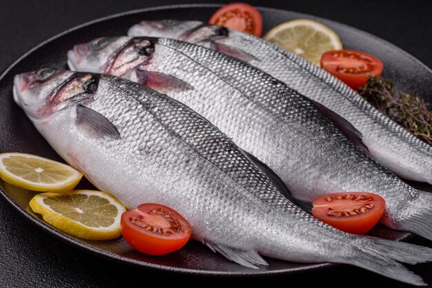 Foto pesce di mare fresco e crudo con spezie salate ed erbe