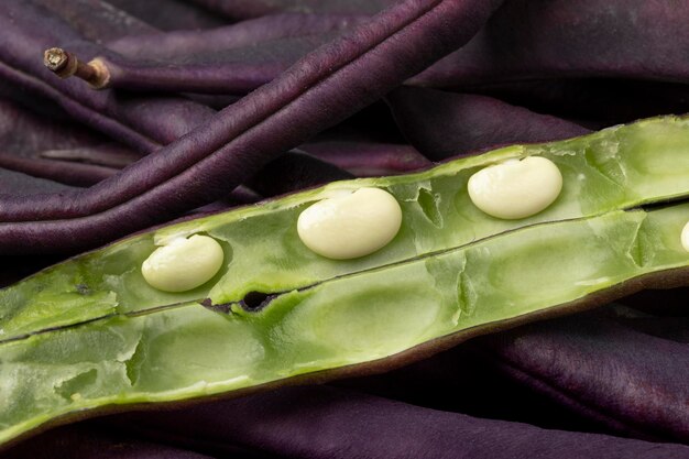 Fresh raw open purple bean green inside close up