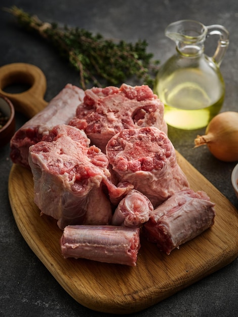 Fresh and raw oxtail cut on the cutting board on a grey background