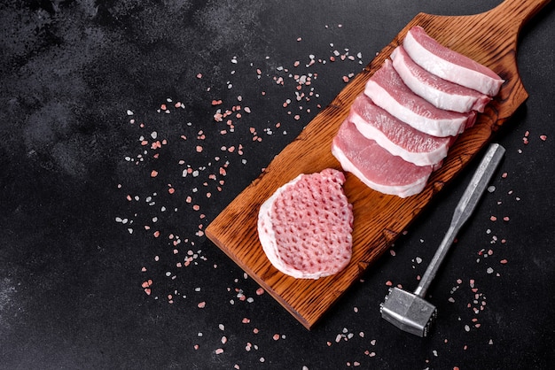 A fresh raw piece of pork escalop cut into several parts