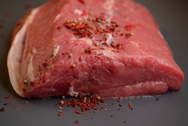 Fresh raw pork and beef meat. Piece of fresh red meat. A large piece of fresh meat lying on a cutting board. A piece of fresh beef.