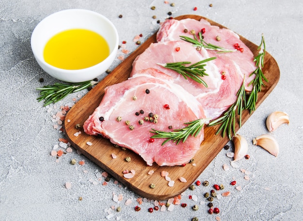 Fresh raw pork chops with spices and herbs