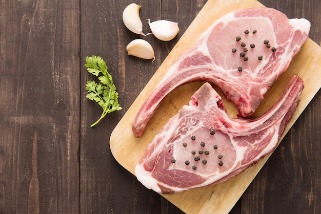 Fresh Raw Pork Chops on wood