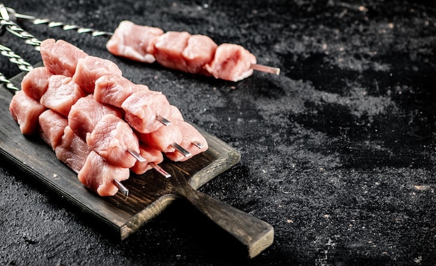 Fresh raw pork kebab on a cutting board