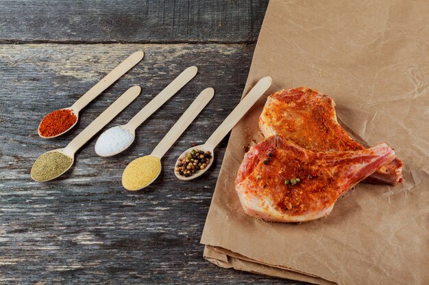 Fresh raw pork loin with bay leaf on wooden board and on the background