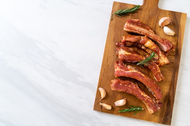 Fresh raw pork ribs ready for roasting with ingredients