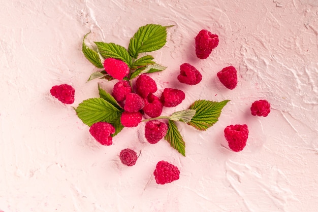 Fresh raw raspberries with green leaves