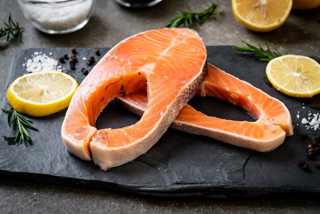 fresh raw salmon fillet steak with ingredient on board