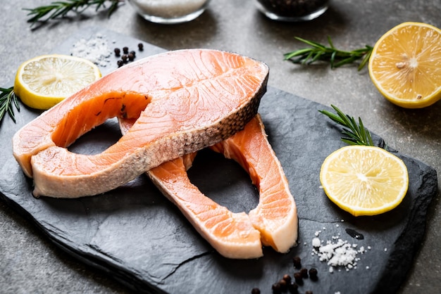 fresh raw salmon fillet steak with ingredient on board