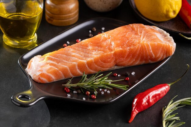 Fresh raw salmon fillet with ingredients for preparation