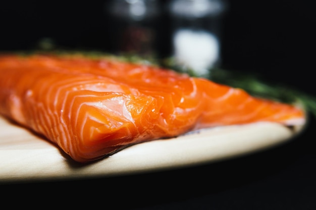 Fresh raw salmon fillet with seasonings and herbs