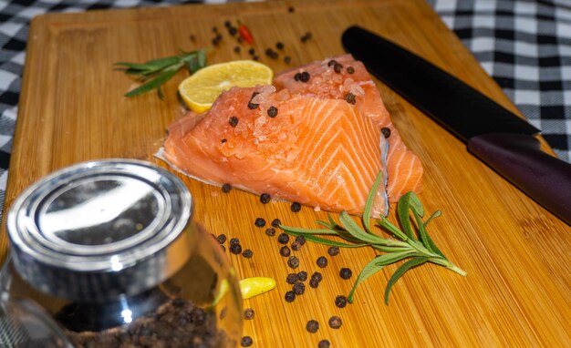 Fresh raw salmon fillet on wooden cutting board