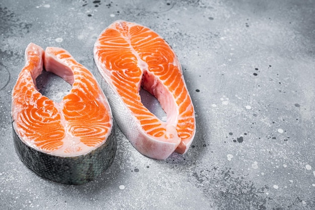 Fresh Raw Salmon Fish Steaks Gray background Top view Copy space